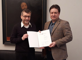 Prof. Walter Rosenthal, President of Friedrich Schiller University Jena, hands over the document of appointment to Prof. Tomáš Čižmár. Foto: private